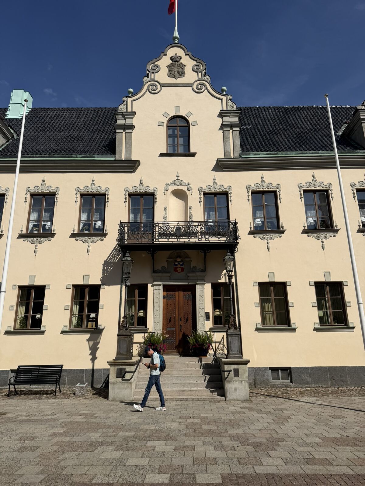 Fachada amarilla del ayuntamiento de Malmö con bandera danesa